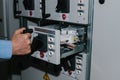 Electrician specialist checking low-voltage cabinet equipment