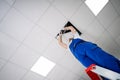 Electrician On Stepladder Installs Lighting To The Ceiling Royalty Free Stock Photo