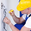 Electrician stripping electrical wires Royalty Free Stock Photo