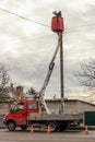 Electrician technician on the bucket of the truck aerial platform Royalty Free Stock Photo