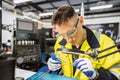 Electrician technician caucasian male using hot soldering iron to electrical bond electricity wire fix repair power line cable Royalty Free Stock Photo