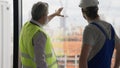 Electrician technician and contractor foreman talking together on building site