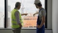 Electrician technician and contractor foreman talking together on building site