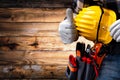 Electrician technician with tool belt on rustic wooden background. Electricity Royalty Free Stock Photo