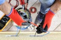 Electrician technician at work with safety equipment on a residential electrical system Royalty Free Stock Photo