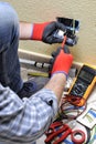 Electrician technician at work with safety equipment on a residential electrical system Royalty Free Stock Photo