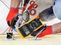 Electrician technician at work with safety equipment on a residential electrical system Royalty Free Stock Photo