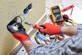 Electrician technician at work with safety equipment on a residential electrical system