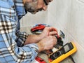 Electrician technician at work on a residential electric system.