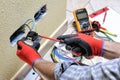 Electrician technician at work with safety equipment on a residential electrical system Royalty Free Stock Photo