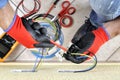 Electrician technician at work with safety equipment on a residential electrical system Royalty Free Stock Photo