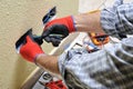 Electrician technician at work with safety equipment on a residential electrical system Royalty Free Stock Photo