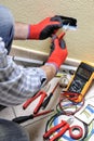 Electrician technician at work with safety equipment on a residential electrical system Royalty Free Stock Photo