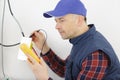 electrician testing cables with multimeter Royalty Free Stock Photo
