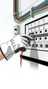 Electrician testing electrical panel with multimeter Royalty Free Stock Photo