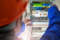 Electrician testing the electrical shield. Royalty Free Stock Photo