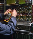 Electrician testing industrial machine