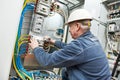 Electrician tighten the screws with spanner Royalty Free Stock Photo