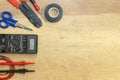 Electrician tools, components and instruments on a wooden background