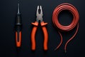 Electrician tools on black background. Top view with copy space. Royalty Free Stock Photo