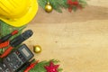 Electrician tools and instruments and Christmas decorations on wooden background