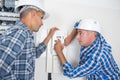 Electrician training an apprentice Royalty Free Stock Photo