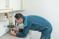 An electrician unscrews a socket with a screwdriver. Royalty Free Stock Photo
