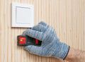 Electrician using the cable detector scans the wall to find hidden wiring, work in the house, close up Royalty Free Stock Photo
