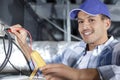 electrician using multimeter in roof space