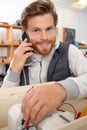 electrician using multimeter and talking on smartphone Royalty Free Stock Photo