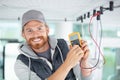 electrician using multimeter to test spotlight connections Royalty Free Stock Photo
