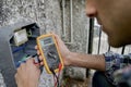 Electrician using voltmeter device Royalty Free Stock Photo