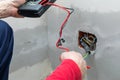 Electrician using voltmeter