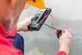 Electrician using voltmeter