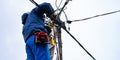 The electrician vysotnik makes installation of power grids