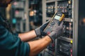 Electrician Testing Electrical Panel with Digital Multimeter in Royalty Free Stock Photo