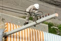 Electrician wiring on a electric pole