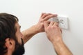 Electrician wiring a new build. Worker installing socket in new house Royalty Free Stock Photo