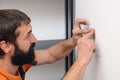 Electrician wiring a new build. Worker installing socket in new house Royalty Free Stock Photo