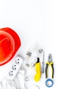 Electrician work concept. Hard hat, tools, socket outlet on white background top view Royalty Free Stock Photo