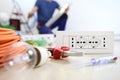 Electrician work with electrical equipment in the foreground, bulb, tools and socket, electric circuits, electrical wiring. Royalty Free Stock Photo