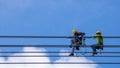 Electrician work installation of high voltage cable in high voltage safely and systematically over and blue sky background