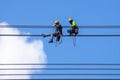 Electrician work installation of high voltage cable in high voltage safely and systematically over and blue sky background Royalty Free Stock Photo