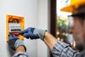 Electrician at work with safety equipment on a residential electrical system. Electricity