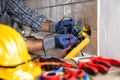 Electrician at work with safety equipment on a residential electrical system. Electricity Royalty Free Stock Photo
