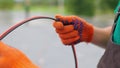 An electrician worker holds a red and black high-voltage electric cable, checks the quality of the cables. Connecting Royalty Free Stock Photo