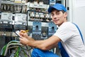 electrician worker inspecting equipment and electricity meter Royalty Free Stock Photo