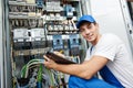 electrician worker inspecting equipment and electricity meter Royalty Free Stock Photo