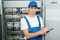 electrician worker inspecting equipment and electricity meter Royalty Free Stock Photo