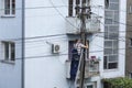 Electrician worker on ladder repair electrical system on electricity pillar or Utility pole